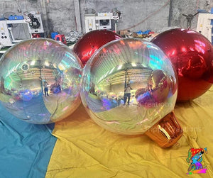 Holographic inflatable balls on a colorful surface with a blurred background