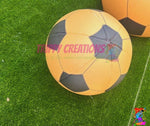Yellow and black soccer ball on green grass with 'tippy Creations' branding.