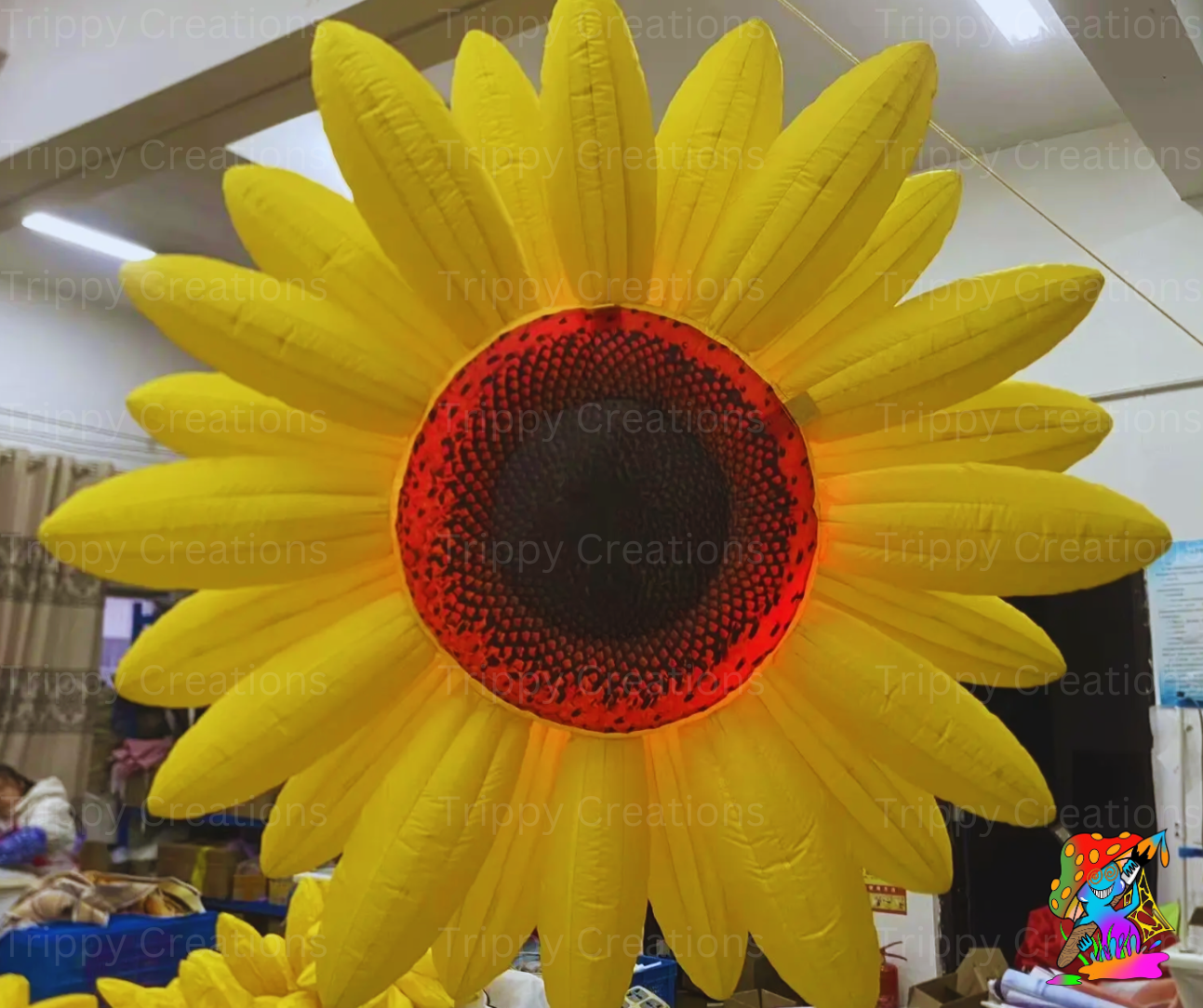 giant inflatable sunflower party decoration hanging from ceiling

