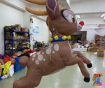 Inflatable reindeer decoration in a warehouse setting with shelves and various items in the background.