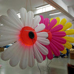 Trippy Creations giant inflatable daisy flower decorations in white, pink, and yellow with LED lights.