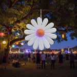Trippy Creations giant white inflatable daisy flower decoration with orange center and purple LED lights, made of polyester taffeta.