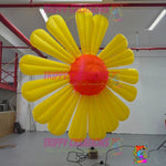 Giant yellow inflatable daisy flower decoration with orange center, made of polyester taffeta. Ideal for events.