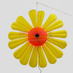 Trippy Creations giant yellow inflatable daisy flower decoration with orange center and LED lights, made of polyester taffeta.