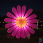 Trippy Creations giant pink inflatable daisy flower decoration with orange center, polyester taffeta, for events.