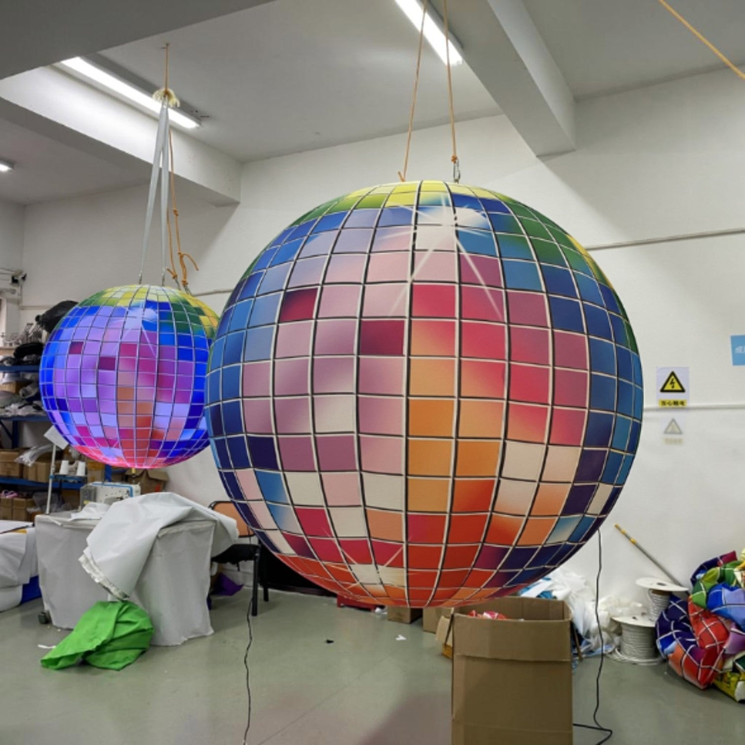 Trippy Creations giant inflatable disco ball decoration with rainbow colored squares, lit from within.