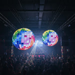 Trippy Creations giant inflatable disco ball decoration with rainbow-colored squares, hanging indoors.