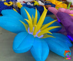 Trippy Creations giant blue and yellow inflatable flower decoration with LED lights, perfect for whimsical events.