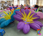 Trippy Creations giant purple and blue inflatable flower decorations with yellow centers, perfect for whimsical events.