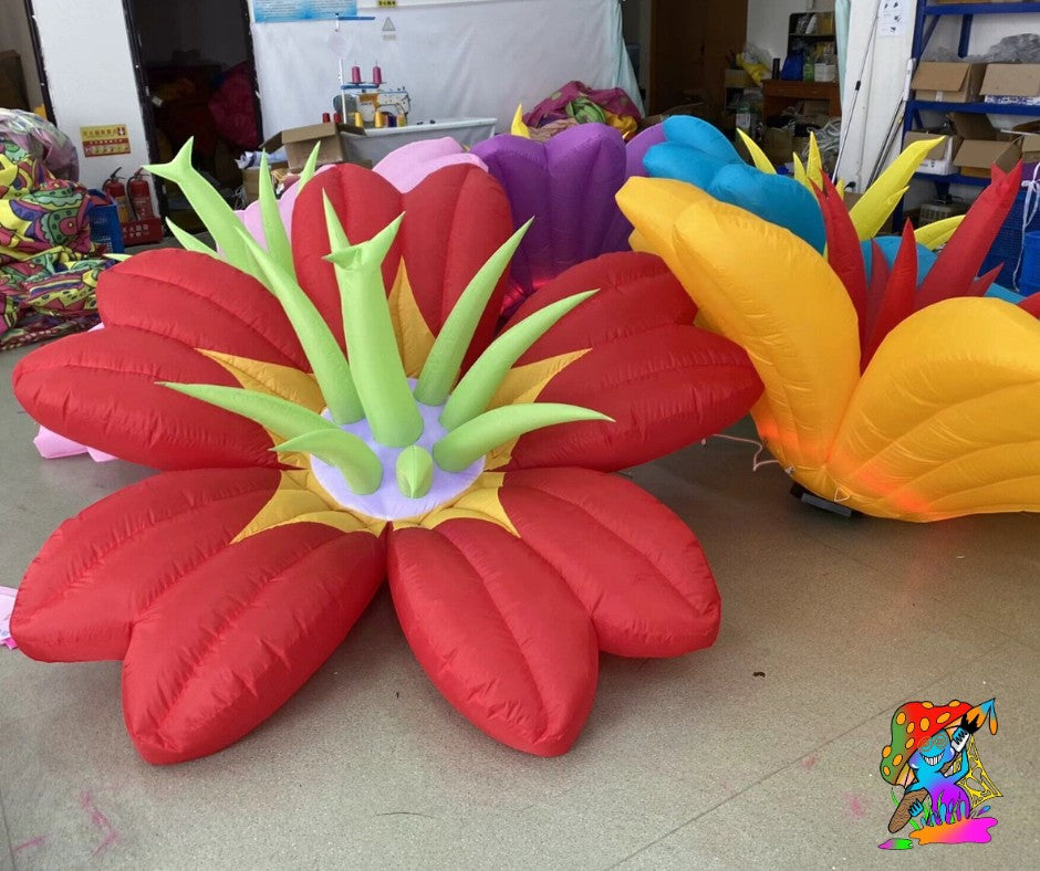 Trippy Creations giant red and yellow inflatable flower decoration with green accents, perfect for whimsical events.