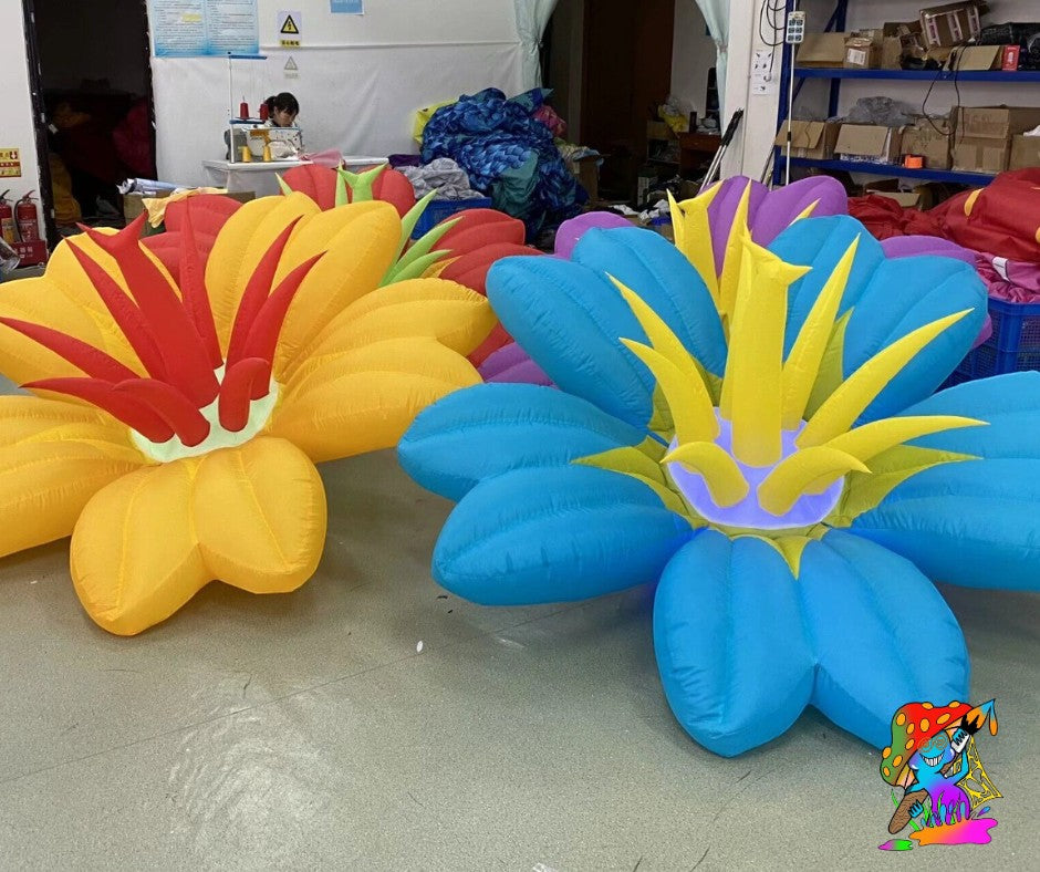 Trippy Creations giant inflatable flowers in yellow, red, blue, and purple with yellow centers. Whimsical decor for parties.