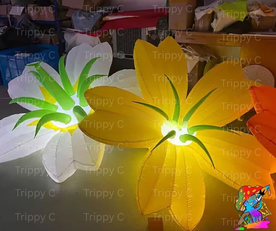 Trippy Creations giant inflatable white and yellow flowers with green accents, illuminated from within.