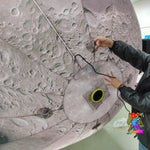 Trippy Creations giant inflatable moon decoration with realistic crater details, perfect for events.