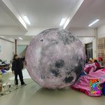 Trippy Creations giant inflatable moon decoration with realistic craters and surface detail, perfect for events.