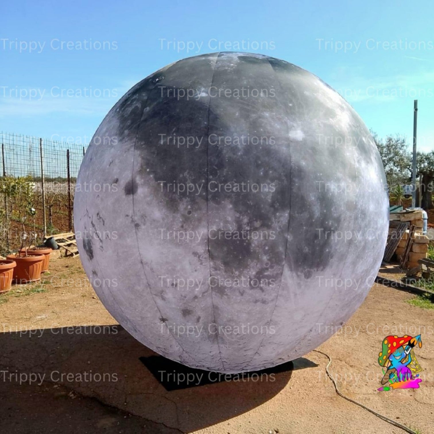 Trippy Creations giant inflatable moon decoration, realistic grey and white surface, perfect for parties and events.