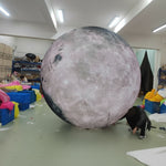 Trippy Creations giant inflatable moon decoration with realistic surface detail, perfect for events and parties.