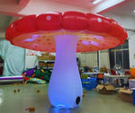 Trippy Creations giant red inflatable mushroom with white polka dots and LED lighting, perfect for parties.