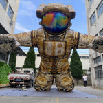 Trippy Creations giant inflatable astronaut with rainbow visor and "Badass Tronuts" logo on chest.