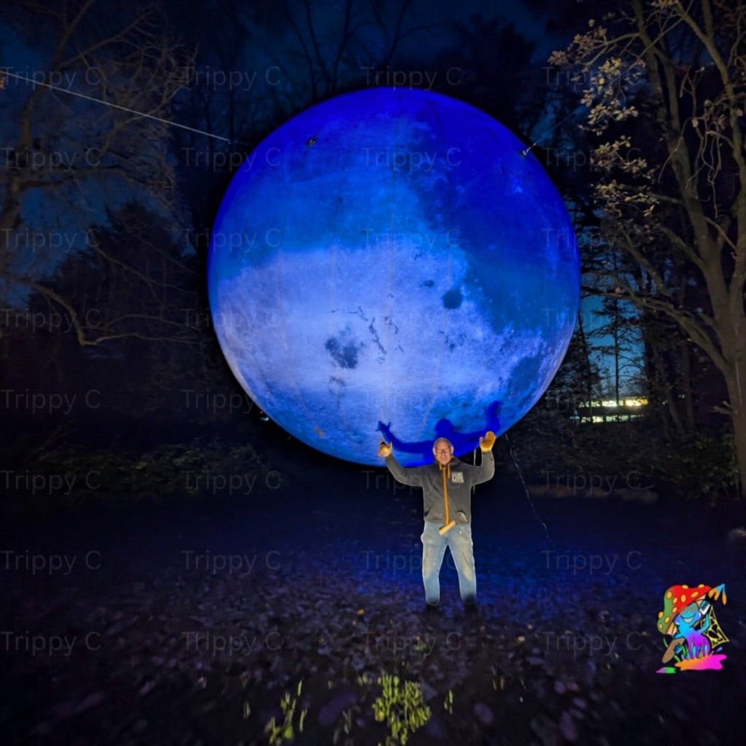 Trippy Creations giant blue LED inflatable moon decoration, a man stands beneath it.