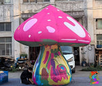 Trippy Creations giant pink fairy mushroom inflatable decoration with white spots on cap and psychedelic stem.