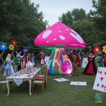 Trippy Creations giant pink inflatable mushroom with white spots and a psychedelic stem, made of Oxford fabric.