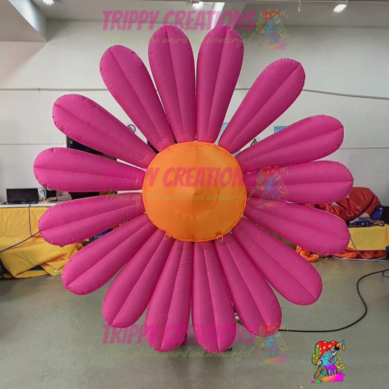Trippy Creations giant pink inflatable daisy flower with orange center, polyester taffeta, for events and decor.