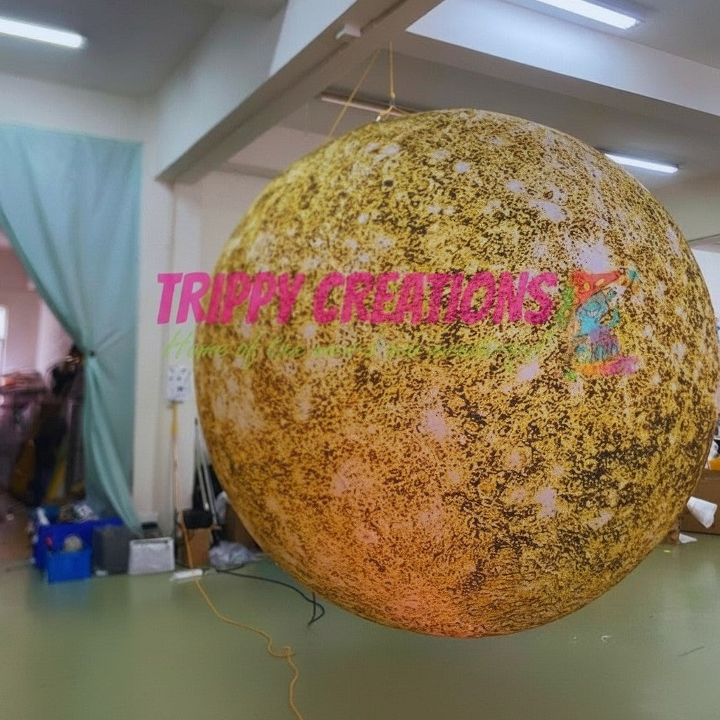 Trippy Creations giant inflatable Jupiter planet, yellow and brown speckled, for space-themed events and hanging installations.