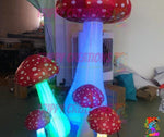 Trippy Creations set of 5 red and white inflatable mushrooms with LED lights, perfect for Alice in Wonderland parties.