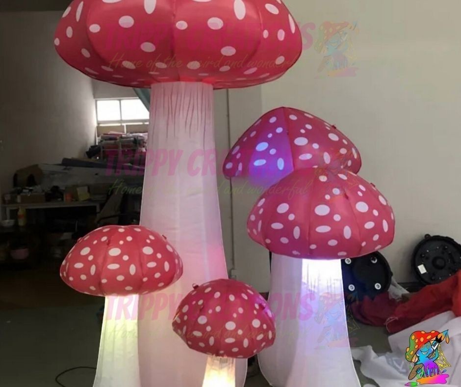 Trippy Creations set of 5 mini LED inflatable mushrooms, red with white spots, for Alice in Wonderland parties and festivals.