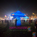 Trippy Creations giant blue inflatable mushroom prop with yellow and pink accents, 3m-3.5m tall, for psychedelic events.
