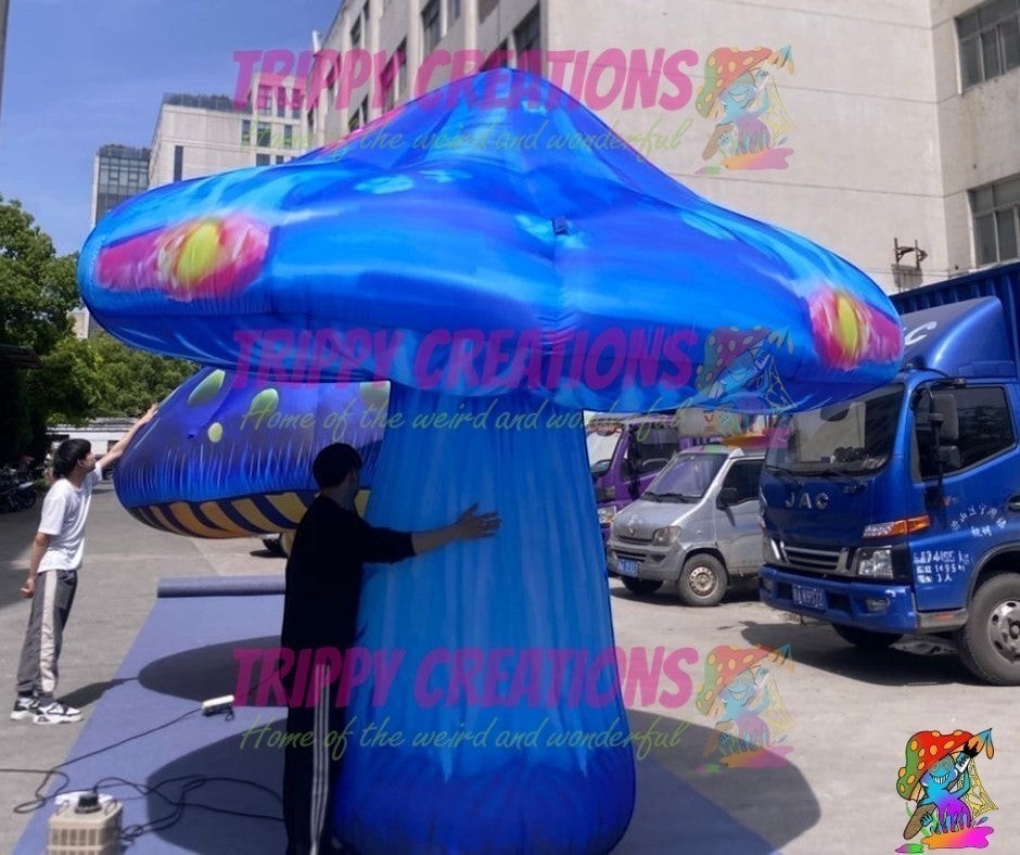 Trippy Creations giant inflatable mushroom prop, 3m-3.5m, blue with psychedelic patterns and glowing accents.