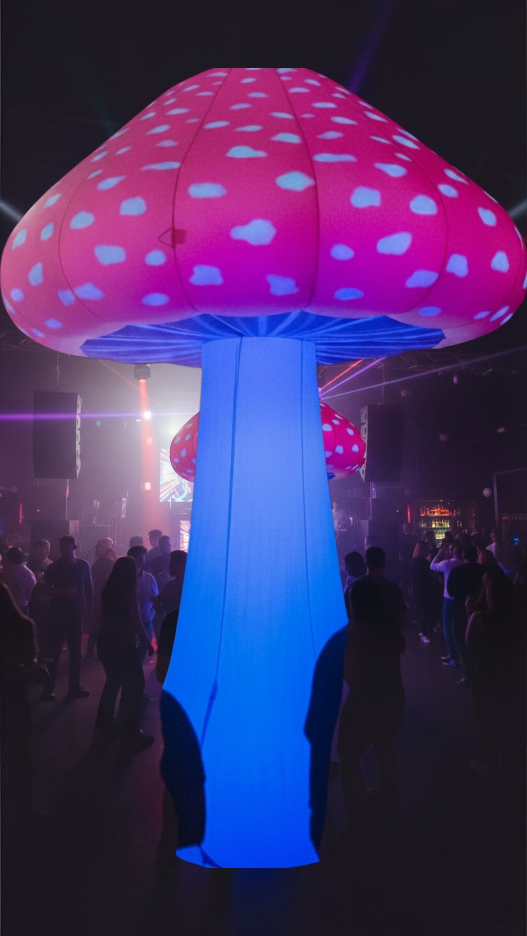 Trippy Creations 3m inflatable mushroom prop with pink cap and blue flashing LED stem, ideal for parties.