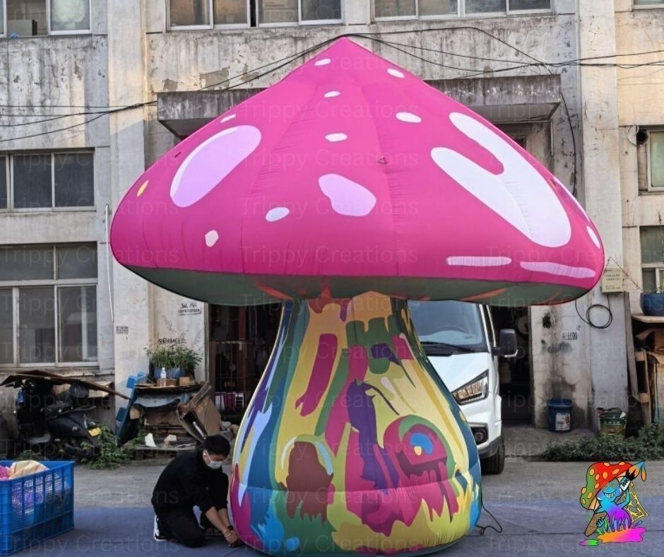 Trippy Creations giant pink inflatable mushroom prop with white spots and a psychedelic stem, 3m-3.5m tall.