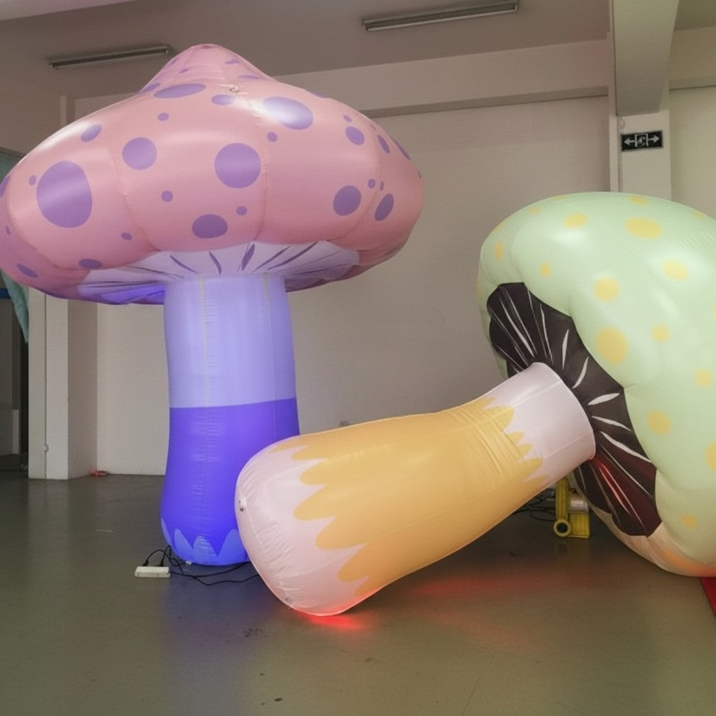 Trippy Creations inflatable mushrooms in pink, purple, green, and yellow with LED lights, perfect for whimsical events.