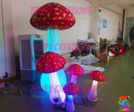 Trippy Creations set of 5 red and white inflatable mushrooms with LED lights, varying sizes, Alice in Wonderland decor