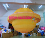 Trippy Creations giant inflatable Saturn planet with rings, yellow and orange, for space-themed events.