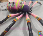 Trippy Creations giant inflatable spider decoration with pink legs and a purple body, featuring a colourful, multi-eyed head.