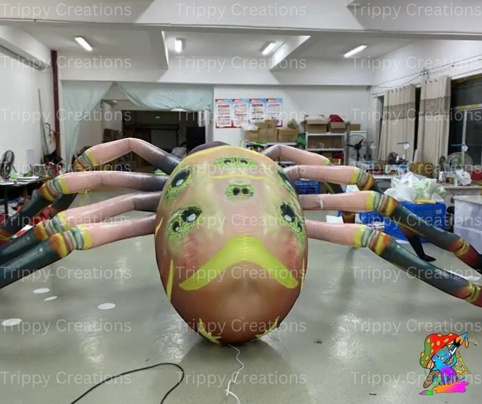 Trippy Creations giant inflatable spider decoration with multiple eyes and segmented legs, ideal for Halloween events.