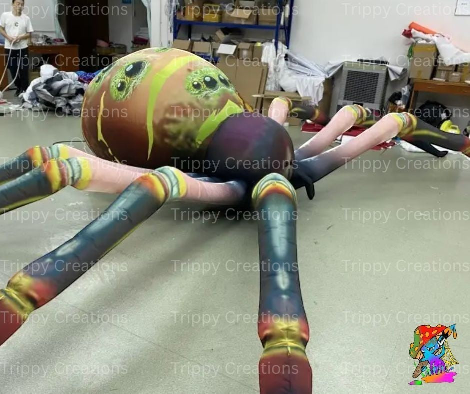 Trippy Creations giant inflatable spider decoration with green eyes and colorful legs, perfect for Halloween events.