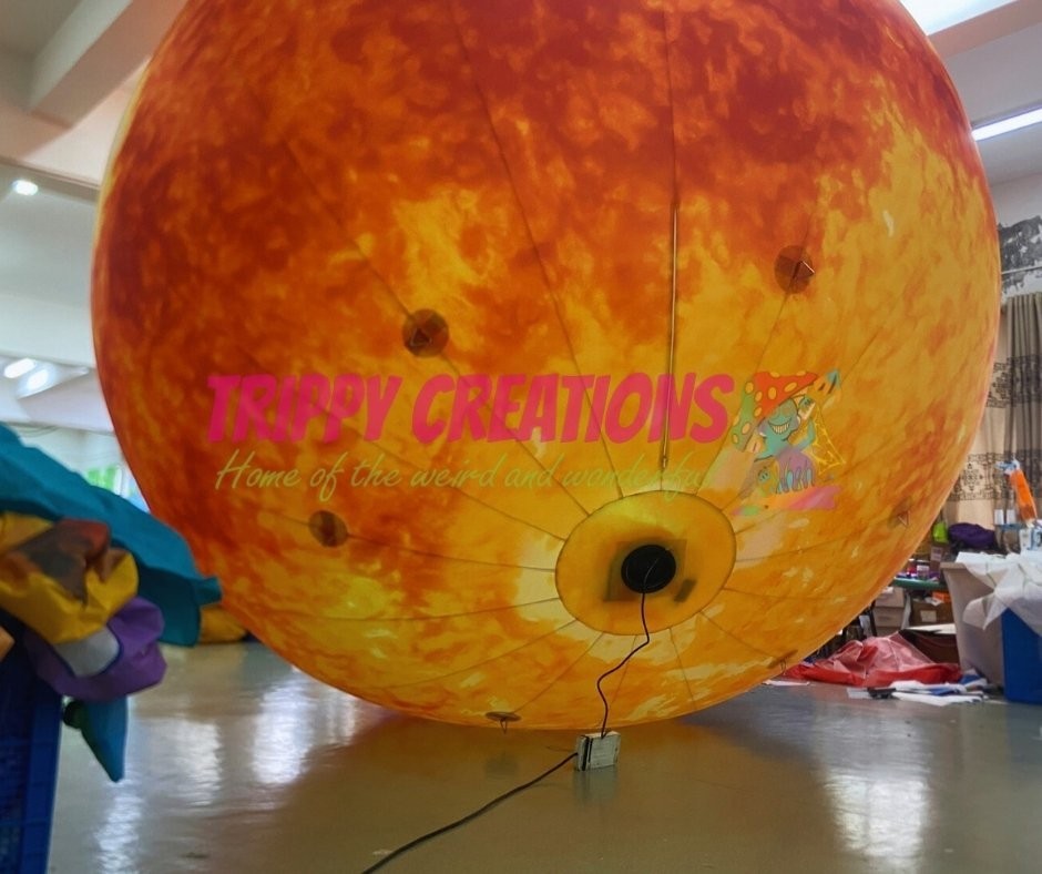 Trippy Creations giant inflatable sun, 5m diameter, perfect for space-themed events and hanging installations.