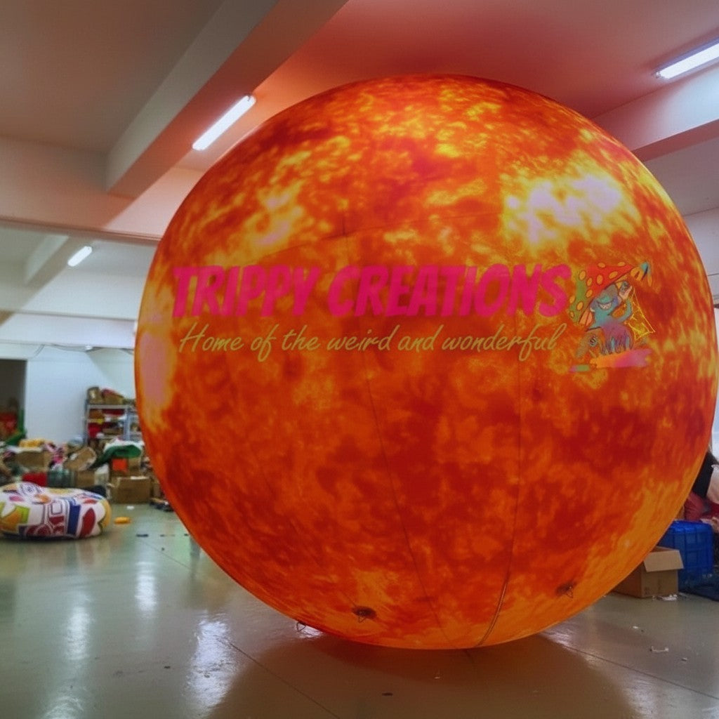 Trippy Creations giant inflatable Sun planet, orange and yellow with fiery texture, ideal for space-themed events.