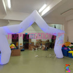 White five-point inflatable star arch photographed during an indoor product display with internal LED illumination.