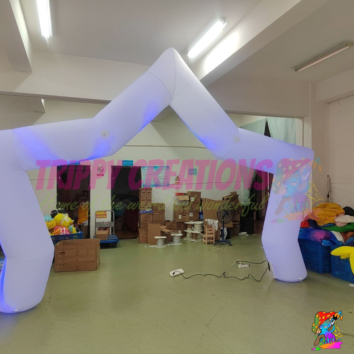White five-point inflatable star arch photographed during an indoor product display with internal LED illumination.